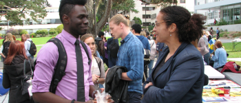 Scholar having conversation at campus fair.